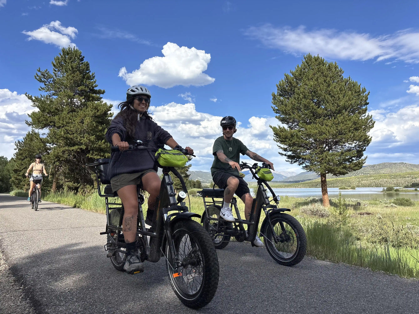 Family riding e-bikes together on paved Summit County trail near Lake Dillon Colorado