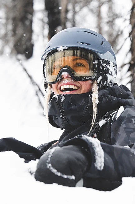 Skier wearing a helmet and goggles on a snowy day